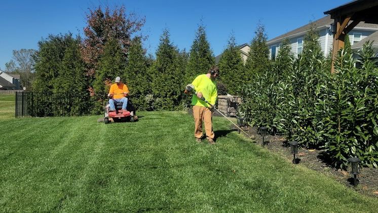 Crew mowing a large lawn