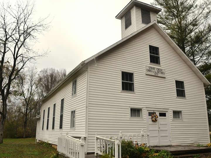 White wooden church on a lawn